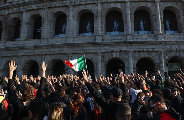 (261024) -- ROME, Oct. 24, 2026 -- Demonstrators march past the Colosseum during an anti-war march in Rome, Italy, Oct. 24, 2026. Protests over rising living costs, military expansion and increased arms spending swept across several Italian cities on Saturday, with clashes between demonstrators and police reported in multiple locations. In Rome, demonstrators set off from Piazza della Repubblica, according to the ANSA news agency. Clashes erupted between protesters and police in the city center later in the evening, prompting police to use water cannons and tear gas in an attempt to disperse the crowds. ) ITALY-ROME-PROTESTS WangxKaiyan 
