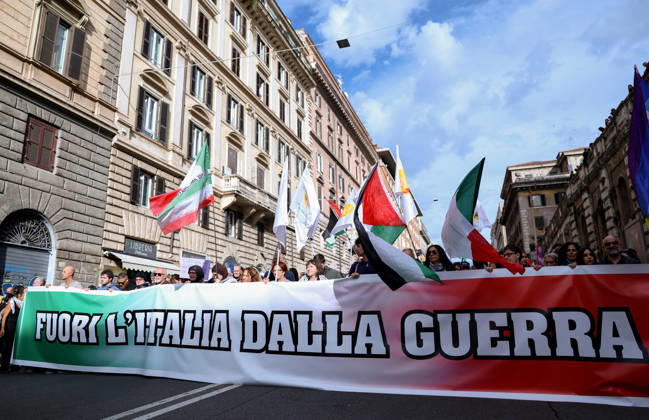(261024) -- ROME, Oct. 24, 2026 -- Demonstrators are seen during an anti-war march in Rome, Italy, Oct. 24, 2026. Protests over rising living costs, military expansion and increased arms spending swept across several Italian cities on Saturday, with clashes between demonstrators and police reported in multiple locations. In Rome, demonstrators set off from Piazza della Repubblica, according to the ANSA news agency. Clashes erupted between protesters and police in the city center later in the evening, prompting police to use water cannons and tear gas in an attempt to disperse the crowds. ) ITALY-ROME-PROTESTS WangxKaiyan 