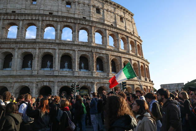 (261024) -- ROME, Oct. 24, 2026 -- Demonstrators march past the Colosseum during an anti-war march in Rome, Italy, Oct. 24, 2026. Protests over rising living costs, military expansion and increased arms spending swept across several Italian cities on Saturday, with clashes between demonstrators and police reported in multiple locations. In Rome, demonstrators set off from Piazza della Repubblica, according to the ANSA news agency. Clashes erupted between protesters and police in the city center later in the evening, prompting police to use water cannons and tear gas in an attempt to disperse the crowds. ) ITALY-ROME-PROTESTS WangxKaiyan 