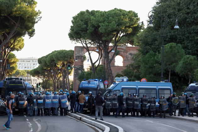 (261024) -- ROME, Oct. 24, 2026 -- Police stand guard near Circo Massimo for an anti-war march in Rome, Italy, Oct. 24, 2026. Protests over rising living costs, military expansion and increased arms spending swept across several Italian cities on Saturday, with clashes between demonstrators and police reported in multiple locations. In Rome, demonstrators set off from Piazza della Repubblica, according to the ANSA news agency. Clashes erupted between protesters and police in the city center later in the evening, prompting police to use water cannons and tear gas in an attempt to disperse the crowds. ) ITALY-ROME-PROTESTS WangxKaiyan 