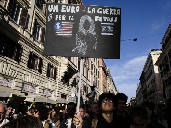 Rome Anti War Protest A demonstrator holds a sign reading One euro for war, zero for the future during an anti-war protest in Rome, Italy on October 24, 2026. Demonstrators took part in an anti-war march under the slogan Keep Italy Out of the War . Protesters further voiced opposition to Italy s involvement in armed conflicts, military rearmament and government policies. Rome Lazio Italy Copyright: xAndreaxCalandrax