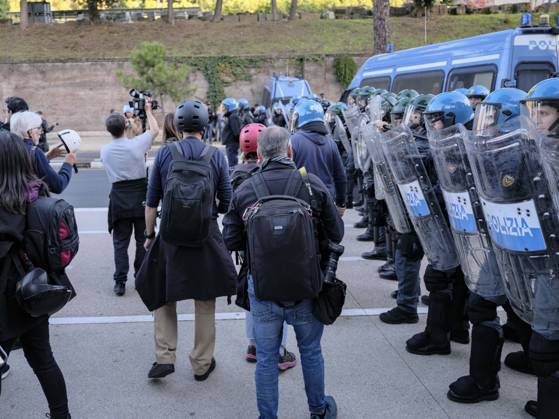 Rome Anti War Protest Police officers stand guard near demonstrators in Rome, Italy on October 24, 2026. Demonstrators took part in an anti-war march under the slogan Keep Italy Out of the War . Protesters further voiced opposition to Italy s involvement in armed conflicts, military rearmament and government policies. Rome Lazio Italy Copyright: xAndreaxCalandrax