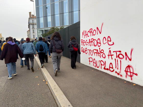 Lyon France Protests October 24 Demonstrators walk past graffiti reading Macron, remember what you are doing to your people during a protest in Lyon, France on October 24, 2026. Authorities deployed around 70,000 security personnel across France for renewed protests over the cost of living, after unrest a week earlier saw public buildings damaged, hundreds of shops looted and about 2,700 people arrested. Lyon Rhone Alpes France Copyright: xAbolfazlxSalmanzadehx