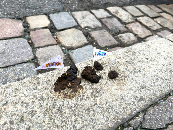 Lyon France Protests October 24 flags reading MACRON and NUNEZ stick out of feces on a sidewalk curb during a protest in Lyon, France on October 24, 2026. Authorities deployed around 70,000 security personnel across France for renewed protests over the cost of living, after unrest a week earlier saw public buildings damaged, hundreds of shops looted and about 2,700 people arrested. Lyon Rhone Alpes France Copyright: xAbolfazlxSalmanzadehx
