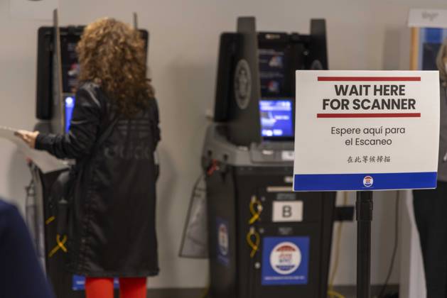 October 24, 2026, New York, New York, USA: A Lower Manhattan resident scans their ballot at the Borough of Manhattan Community College polling site in Tribeca on the first day of early voting for the midterm elections in New York. New York USA - ZUMAr174 20261024_znp_r174_010 Copyright: xGinaxMxRandazzox