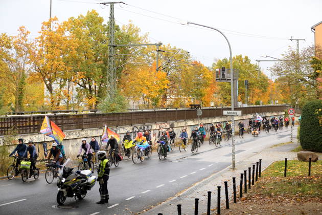 Protesters ride down Friedrich Engels Street waving rainbow flags during Bike Pride in Potsdam, October 24, 2026 Bike Pride Potsdam