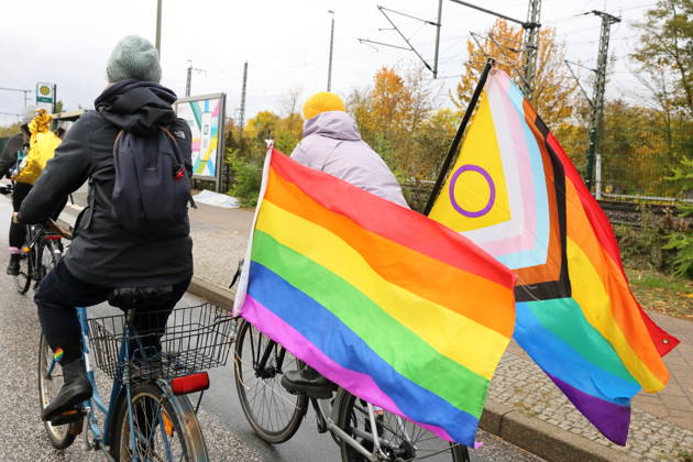 Protesters ride down Friedrich Engels Street waving rainbow flags during Bike Pride in Potsdam, October 24, 2026 Bike Pride Potsdam