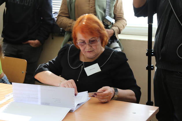 (261025) -- SOFIA, Oct. 25, 2026 -- A staff member checks information during the presidential election at a polling station in Sofia, Bulgaria, Oct. 25, 2026. Bulgarians went to the polls on Sunday to elect their next president. As many as 6.59 million voters are eligible to choose from 27 candidates, including incumbent President Iliana Iotova, according to the country s Central Election Commission. Polling stations across the country opened at 7:00 a.m. local time (0500 GMT) and are scheduled to close at 8:00 p.m. The first exit polls may be released immediately after voting ends, while the official results must be announced no later than Tuesday evening. ) BULGARIA-SOFIA-PRESIDENTIAL ELECTION-VOTING LinxHao 