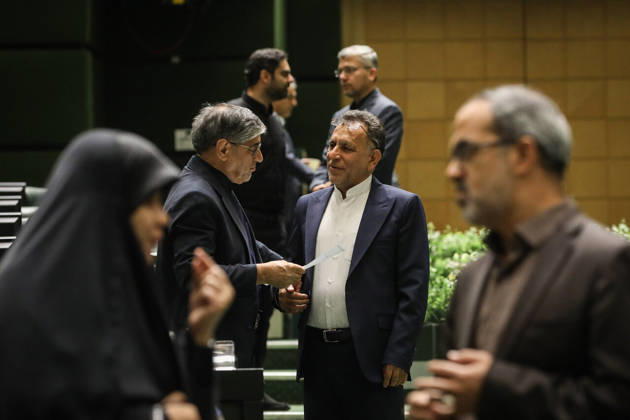 October 25, 2026, Tehran, Iran: A suited lawmaker reaches to shake hands with a colleague while another man watches in the foreground at the Islamic Consultative Assembly in Tehran, Iran, on October 25, 2026. The Iranian parliament held a hybrid open sitting, with some lawmakers attending in the Tehran chamber and others participating remotely, according to parliamentary reports. Tehran Iran - ZUMAi98_ 20261025_zih_i98_083 Copyright: xIcanax