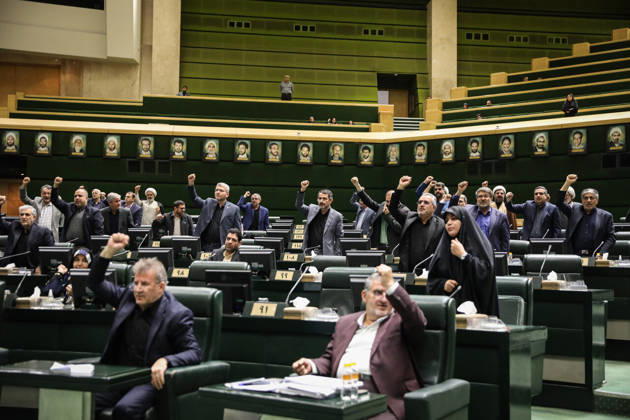 October 25, 2026, Tehran, Iran: Rows of lawmakers raise their hands while others remain seated beneath portraits on the chamber wall at the Islamic Consultative Assembly in Tehran, Iran, on October 25, 2026. Speaker Mohammad Bagher Ghalibaf chaired the October 25 session, which combined physical attendance at the Islamic Consultative Assembly with participation by video link. Tehran Iran - ZUMAi98_ 20261025_zih_i98_101 Copyright: xIcanax