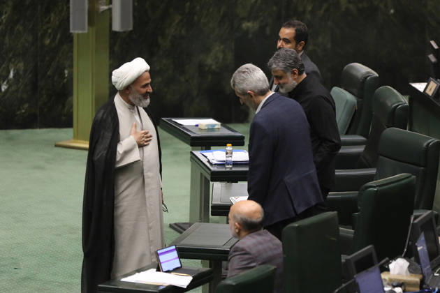 October 25, 2026, Tehran, Iran: A white-turbaned cleric talks with a man leaning toward him between rows of parliament benches at the Islamic Consultative Assembly in Tehran, Iran, on October 25, 2026. Parliamentary reports said more than two-thirds of lawmakers joined the October 25 open sitting of the Islamic Consultative Assembly, attending either in person or remotely. Tehran Iran - ZUMAi98_ 20261025_zih_i98_110 Copyright: xIcanax