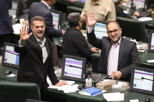 October 25, 2026, Tehran, Iran: A dark-haired lawmaker raises both hands in greeting while another suited man smiles beside him in the chamber at the Islamic Consultative Assembly in Tehran, Iran, on October 25, 2026. Speaker Mohammad Bagher Ghalibaf chaired the October 25 session, which combined physical attendance at the Islamic Consultative Assembly with participation by video link. Tehran Iran - ZUMAi98_ 20261025_zih_i98_116 Copyright: xIcanax
