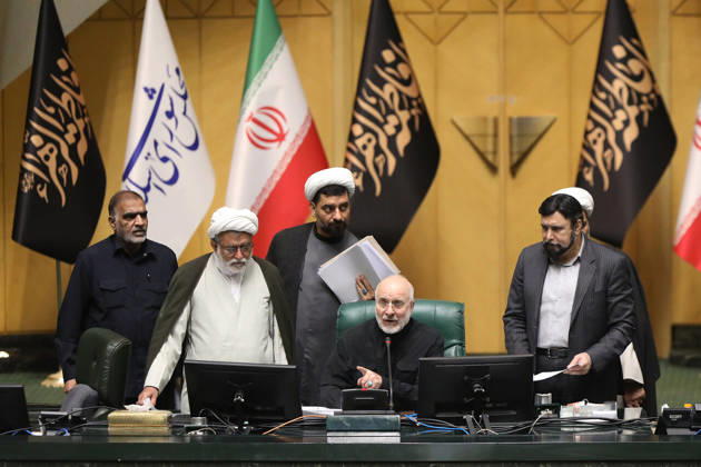 October 25, 2026, Tehran, Iran: Mohammad Bagher Ghalibaf sits at the presiding desk with four male officials standing beside him beneath Iranian flags at the Islamic Consultative Assembly in Tehran, Iran, on October 25, 2026. Speaker Mohammad Bagher Ghalibaf chaired the October 25 session, which combined physical attendance at the Islamic Consultative Assembly with participation by video link. Tehran Iran - ZUMAi98_ 20261025_zih_i98_119 Copyright: xIcanax