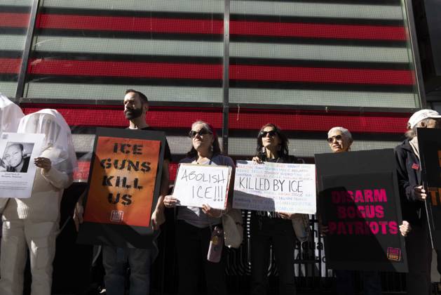 October 25, 2026, New York, New York, USA: Demonstrators with the anti-gun violence organization Gays Against Guns protest under the Times Square US Army Recruiting Station LED American flag to denounce U.S. Immigration and Customs Enforcement (ICE) and President Trump s immigrant detention and mass deportation policies. Protesters hold signs that read ICE GUNS KILL US ABOLISH ICE!!! KILLED BY ICE. People dressed in white shrouds are Human Beings, memorializing people killed by gun violence from Federal immigration agents by holding signs with their images and names. New York USA  - ZUMAr174 20261025_znp_r174_003 Copyright: xGinaxMxRandazzox
