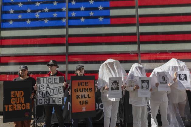 October 25, 2026, New York, New York, USA: Demonstrators with the anti-gun violence organization Gays Against Guns protest under the Times Square US Army Recruiting Station LED American flag to denounce U.S. Immigration and Customs Enforcement (ICE) and President Trump s immigrant detention and mass deportation policies. Protesters hold signs that read END GUN TERROR ICE IS A HATE CRIME ICE GUNS KILL US. People dressed in white shrouds are Human Beings, memorializing people killed by gun violence from Federal immigration agents by holding signs with their images and names. New York USA  - ZUMAr174 20261025_znp_r174_005 Copyright: xGinaxMxRandazzox