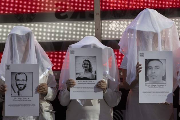 October 25, 2026, New York, New York, USA: People dressed in white shrouds are Human Beings, memorializing people killed by gun violence from Federal immigration agents by holding signs with the images and names of Alex Jeffrey Pretti Renee Nicole Good Silverio Villegas Gonzalez. Demonstrators with the anti-gun violence organization Gays Against Guns protest under the Times Square US Army Recruiting Station LED American flag to denounce U.S. Immigration and Customs Enforcement (ICE,) President Trump s immigrant detention and mass deportation policies. New York USA - ZUMAr174 20261025_znp_r174_015 Copyright: xGinaxMxRandazzox