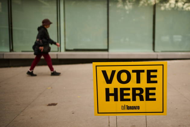 October 26, 2026, Toronto, On, Canada: People pass election signage as they head to the polls to vote in Toronto s municipal election, on Monday, Oct. 26, 2026. Toronto Canada  - ZUMAc35_ 20261026_zaf_c35_046 Copyright: xSammyxKoganx