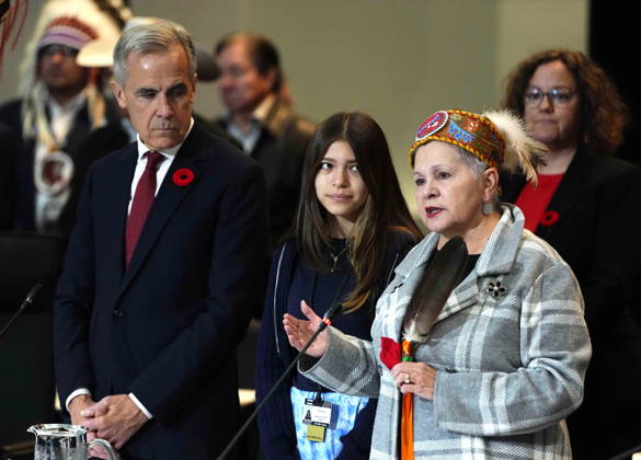 October 26, 2026, Ottawa, On, CAN: Emmi Cote, centre, granddaughter of Elder Claudette Commanda, right, and Prime Minister Mark Carney, listen during the opening prayer at a First Nations and First Ministers Meeting in Ottawa, on Monday, Oct. 26, 2026. Ottawa CAN  - ZUMAc35_ 20261026_zaf_c35_051 Copyright: xJustinxTangx