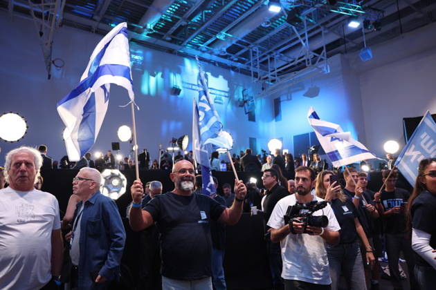(261027) -- TEL AVIV, Oct. 27, 2026 -- A bloc of parties led by former military chief Gadi Eisenkot won 53 seats in Israel s 120-member parliament, ahead of Prime Minister Benjamin Netanyahu s right-wing bloc with 50 seats, according to an exit poll released Tuesday night by Israel s public broadcaster Kan. Neither bloc secured the 61 seats needed to form an outright majority government. This photo taken on Oct. 27, 2026 shows supporters of Gadi Eisenkot at the centrist Yashar party campaign headquarters in Tel Aviv, Israel. ) Photo Flash Exit polls show Netanyahu rival Eisenkot s bloc leading Israeli election, neither bloc wins majority ZhangxHaobo 