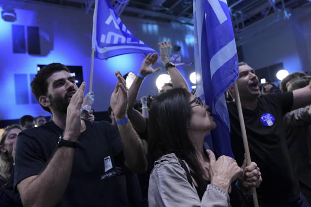Yashar Supporters Celebrate Exit Polls A man claps beside a woman holding a Yashar party flag as another supporter raises an arm and shouts in Tel Aviv, Israel, on October 27, 2026. Supporters of Yashar, the party led by former Israeli military chief Gadi Eisenkot, gathered in Tel Aviv as initial exit polls were released following voting in the 26th Knesset election. Tel Aviv Tel Aviv Israel Copyright: xTomerxNeubergx