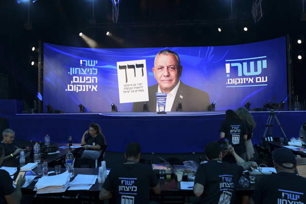 Yashar Supporters Celebrate Exit Polls Campaign staff work at tables facing a stage dominated by a portrait of Yashar leader Gadi Eisenkot and party signs at an election-night venue in Tel Aviv, Israel, on October 27, 2026. The Yashar party, led by former Israeli military chief Gadi Eisenkot, hosted an election-night gathering as Israel voted for its 26th Knesset, with initial television exit polls due after voting closed. Tel Aviv Tel Aviv Israel Copyright: xTomerxNeubergx