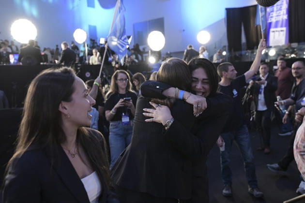 Yashar Supporters Celebrate Exit Polls Two women embrace in the crowd as another woman looks toward them during the Yashar party s election-night gathering in Tel Aviv, Israel, on October 27, 2026. Supporters of Yashar, the party led by former Israeli military chief Gadi Eisenkot, gathered in Tel Aviv as initial exit polls were released following voting in the 26th Knesset election. Tel Aviv Tel Aviv Israel Copyright: xTomerxNeubergx