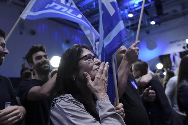 Yashar Supporters Celebrate Exit Polls A woman wearing glasses cups her hand to her mouth as a man raises a Yashar party flag beside her in Tel Aviv, Israel, on October 27, 2026. Supporters of Yashar, the party led by former Israeli military chief Gadi Eisenkot, gathered in Tel Aviv as initial exit polls were released following voting in the 26th Knesset election. Tel Aviv Tel Aviv Israel Copyright: xTomerxNeubergx