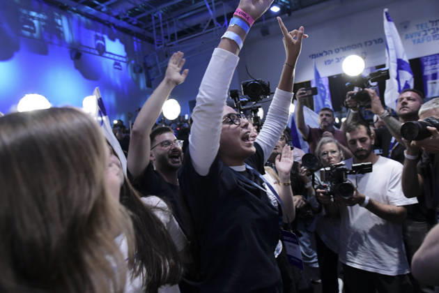 Yashar Supporters Celebrate Exit Polls A woman with glasses raises both arms as supporters celebrate and television camera operators film reactions at the Yashar party election-night gathering in Tel Aviv, Israel, on October 27, 2026. The gathering followed the release of initial television exit-poll projections in Israel s election for the 26th Knesset; the projections were preliminary, not official vote results. Tel Aviv Tel Aviv Israel Copyright: xTomerxNeubergx