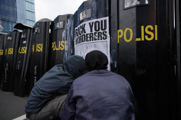 October 28, 2026, Jakarta, Indonesia: Student protesters crouch in front of police riot shields bearing a poster reading Fuck You Murderers during a demonstration at Bundaran HI Jakarta Indonesia - ZUMAm265 20261028_zip_m265_018 Copyright: xAndrixMunazirx