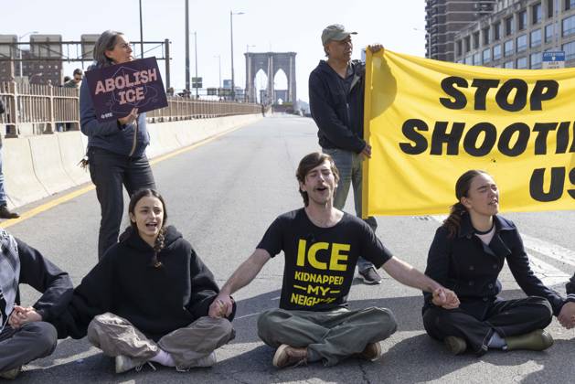 October 28, 2026, New York, New York, USA: Anti-ICE (U.S. Immigration and Customs Enforcement) demonstrators sit in the roadway on the Brooklyn Bridge with a banner and signs that read STOP SHOOTING US ABOLISH ICE protesting the continued detainment of O. Belgal, who was shot by federal agents in the Bronx with his 5-yr-old son in the car. A protester wears a shirt that reads ICE KIDNAPPED MY NEIGHBOR. The demonstration stopped Brooklyn bound traffic and results in arrests by NYPD. Protesters call for ICE out of New York. New York USA - ZUMAr174 20261028_znp_r174_008 Copyright: xGinaxMxRandazzox