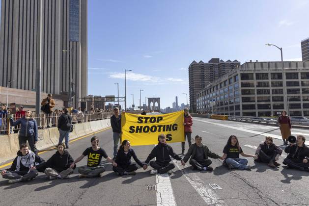 October 28, 2026, New York, New York, USA: Anti-ICE (U.S. Immigration and Customs Enforcement) demonstrators sit in the roadway on the Brooklyn Bridge with a banner that reads STOP SHOOTING US protesting the continued detainment of O. Belgal, who was shot by federal agents in the Bronx with his 5-yr-old son in the car. The demonstration stopped Brooklyn bound traffic and results in arrests by NYPD. Protesters call for ICE out of New York. New York USA - ZUMAr174 20261028_znp_r174_007 Copyright: xGinaxMxRandazzox