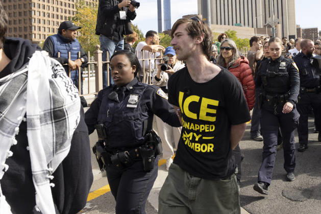 October 28, 2026, New York, New York, USA: Anti-ICE (U.S. Immigration and Customs Enforcement) demonstrators are arrested by NYPD after blockading the roadway and stopping traffic on the Brooklyn Bridge protesting the continued detainment of O. Belgal, who was shot by federal agents in the Bronx with his 5-yr-old son in the car. A protester wears a shirt that reads ICE KIDNAPPED MY NEIGHBOR. Protesters call for ICE out of New York. New York USA - ZUMAr174 20261028_znp_r174_023 Copyright: xGinaxMxRandazzox