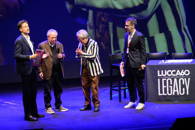 October 28, 2026, Lucca, Lucca, Italy: Vince Tempera, the famous Italian musician and conductor, composer of the theme songs for UFO Robot, Goldrake, and Captain Harlock, meets master comic book artist Go Nagai in a drawing session at the 60th edition of Lucca Comics & Games, Lucca, 28 10 2026 Lucca Italy - ZUMAa289 20261028_zia_a289_197 Copyright: xStefanoxDallexLuchex xAgfx
