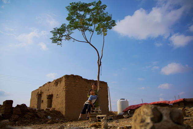 Flooding Damages Al-Talai Displacement Camp A child sits beside a young tree in front of an earthen building and scattered stones at Al-Tala i camp in Al-Hasakah, Syria, on October 29, 2026. Heavy rain on October 28-29 flooded tents at Al-Tala i, also known as Serekaniye camp, which shelters families displaced from Ras al-Ain, damaging bedding and belongings and prompting calls for humanitarian assistance. Al á¸¨asakah Al-Hasakah Syria Copyright: xMohammedxMirx