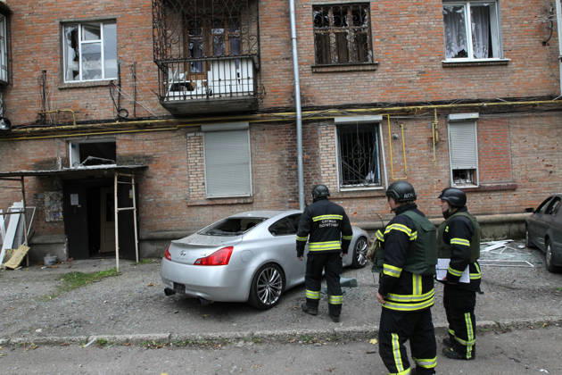 A rescuer approaches a car parked outside an apartment block on Oleksandra Polia Avenue damaged by a Russian drone strike in Dnipro, Ukraine, on October 30, 2026. The Russian attack damaged at least five residential high-rise buildings and a school. More than 300 windows were shattered in the strike. (Photo by Mykola Miakshykov Ukrinform) Russian attack damages residential buildings and school in Dnipro  Copyright: xMykolaxMiakshykovx