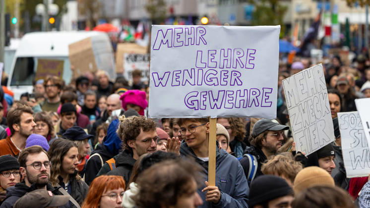 Gen Z Takes Charge: Hundreds March Through the Old Town and Südstadt, Nuremberg, October 31, 2026 Participants in the Gen Z Takes Charge initiative march through the city carrying homemade signs; one sign calls for More Education, fewer guns. The nationwide initiative calls for more fundi 20261031-1V9A3941-M4000
