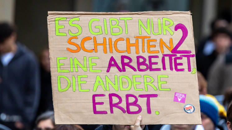 Gen Z Takes Charge: Hundreds March Through the Old Town and Südstadt, Nuremberg, October 31, 2026: At a rally organized by the Gen Z Regelt initiative, a protester holds up a cardboard sign reading, There are only two classes: one works, the other inherits. The nationwid 20261031-1V9A3960-M4000
