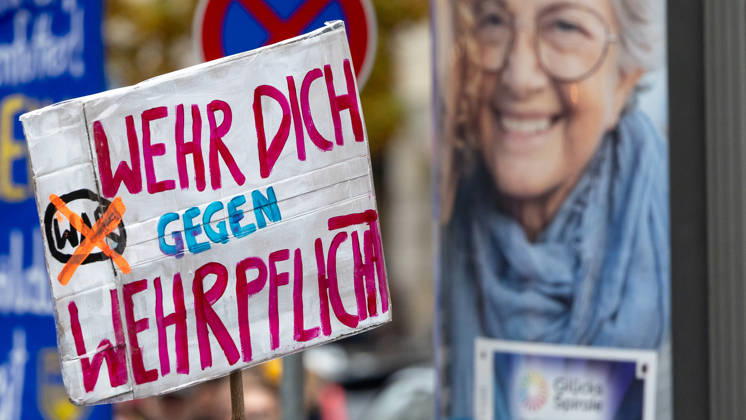 Gen Z Takes Charge: Hundreds March Through the Old Town and Südstadt, Nuremberg, October 31, 2026: At a rally organized by the Gen Z Regelt initiative, a protester holds up a hand-painted sign reading Fight Against Conscription. The nationwide initiative is calling for more funding f 20261031-1V9A3931-M4000
