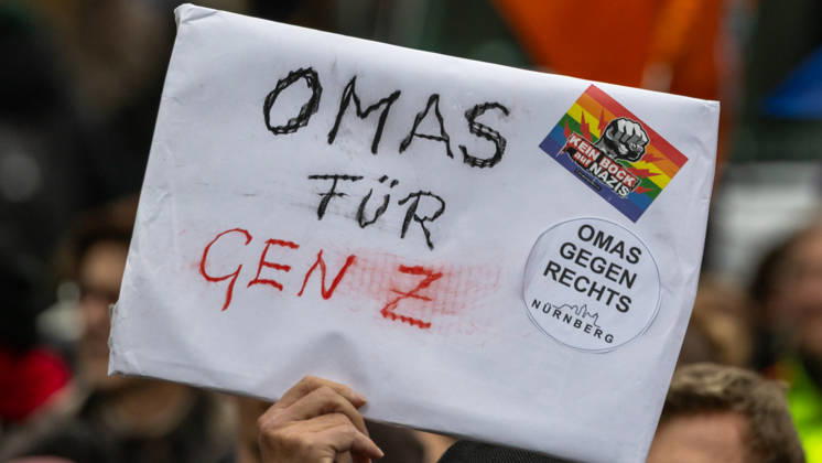 Gen Z Takes Charge: Hundreds March Through the Old Town and Südstadt, Nuremberg, October 31, 2026 A demonstrator holds up a sign reading Grandmas for Gen Z at a rally organized by the Gen Z Regelt initiative. The sign is adorned with sticke 20261031-1V9A3953-M4000
