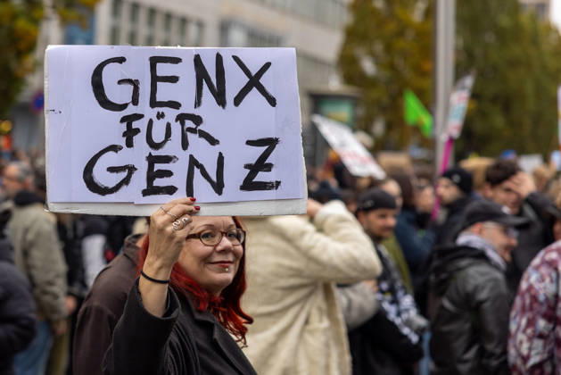 Gen Z Takes Charge: Hundreds March Through the Old Town and Südstadt, Nuremberg, October 31, 2026 A participant in the Gen Z Takes Charge initiative holds up a cardboard sign reading GenX for GenZ during the demonstration. The initiative is calling for action nationwide and demanding more funding fo 20261031-286A1952-M4000