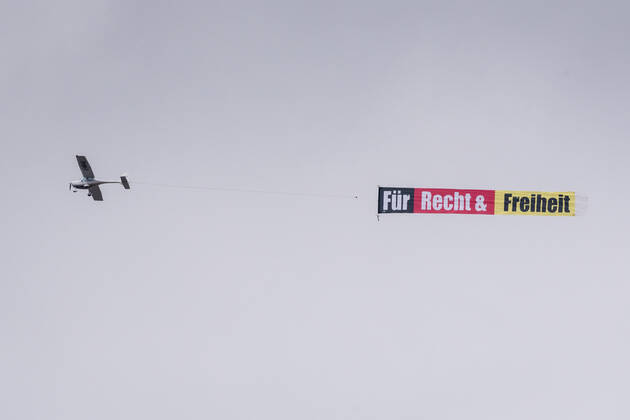 Berlin, airplane with banner For justice and freedom in the sky