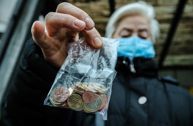 Croatia, woman buys euro starter kit in Zagreb