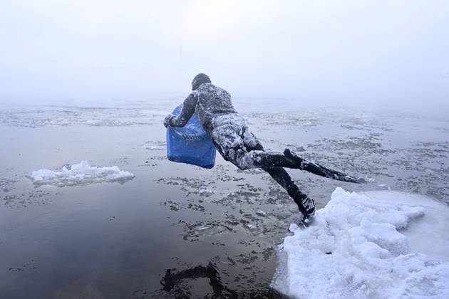 Canada, Montreal man surfs icy Saint Lawrence River
