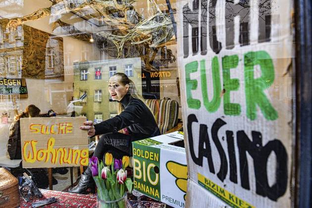 Berlin, artist sits in shop window for art performance to draw attention to housing crisis