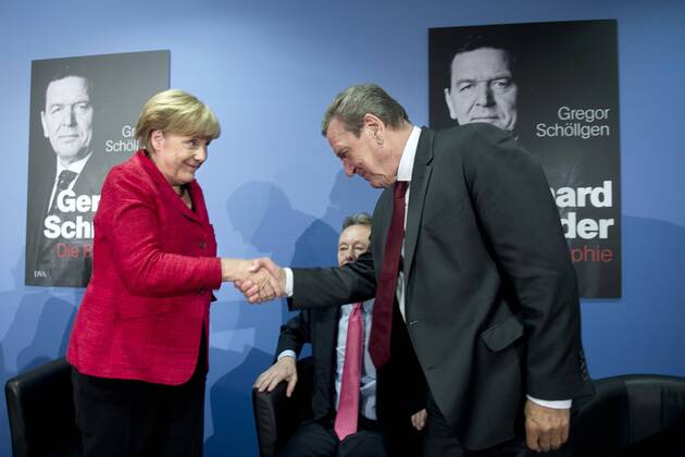 Merkel and former Chancellor Schröder at book presentation in Berlin