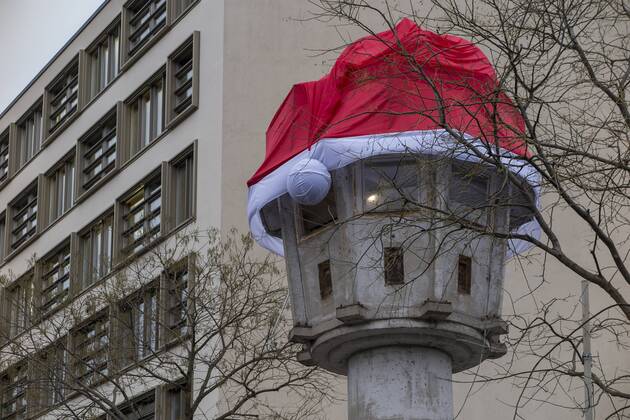 Watchtower of the GDR border troops in Berlin-Mitte decorated with Christmas cap