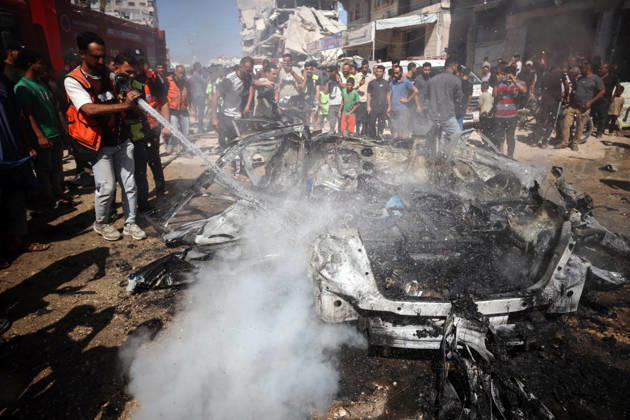 Middle East conflict: Residents put out a fire following an Israeli air strike in Gaza City