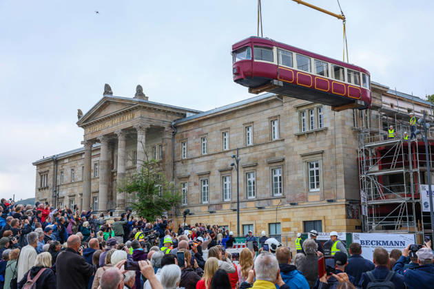 North Rhine-Westphalia: Historic suspension railway carriage hoisted by crane into the station building in Wuppertal
