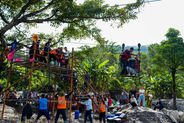 Nepal: People in Nuwakot use an army cable car to cross the river